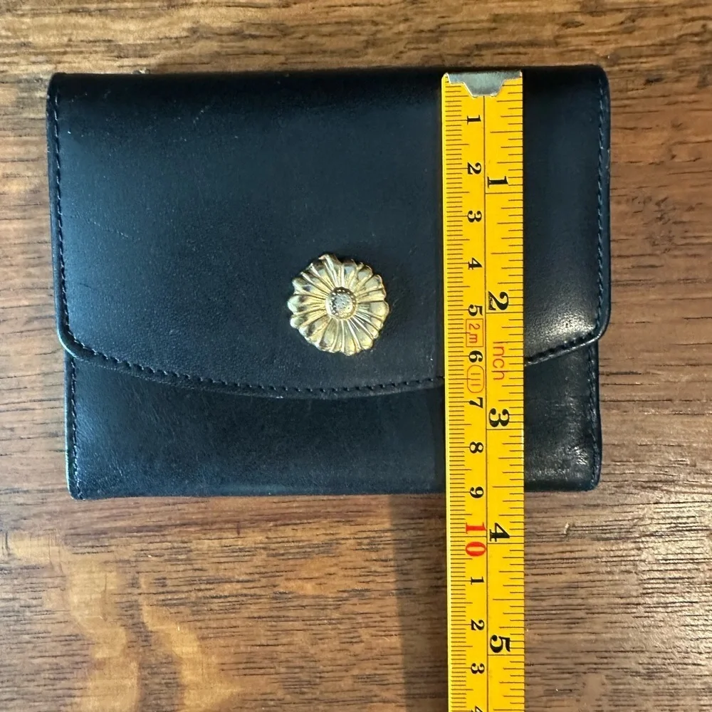 Black leather wallet with a red interior.